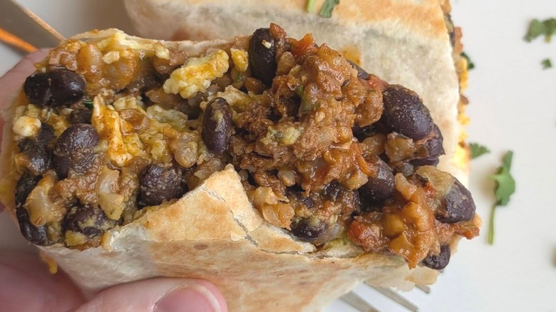 Top of breakfast burrito with bite taken out of it