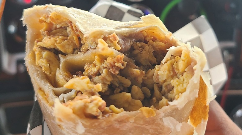 Top of breakfast burrito with bite taken out of it
