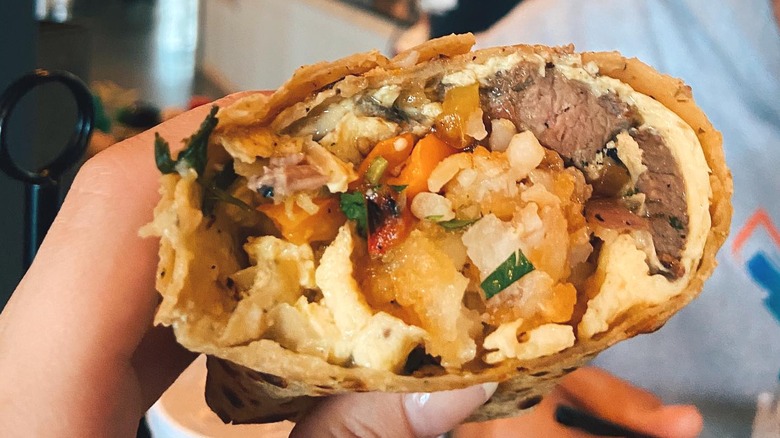 Top of breakfast burrito with bite taken out of it