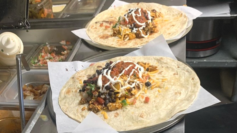 Open-faced breakfast burritos waiting to be rolled