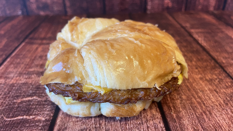 A sausage, egg, and cheese croissant breakfast sandwich from Burger King