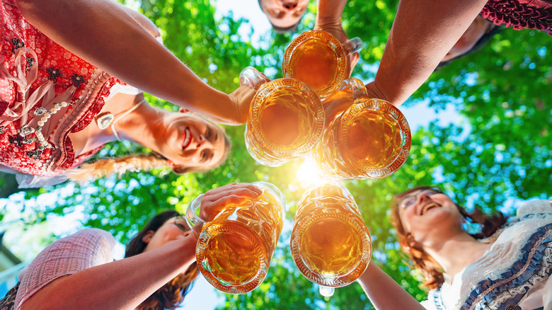 people toasting beer glasses