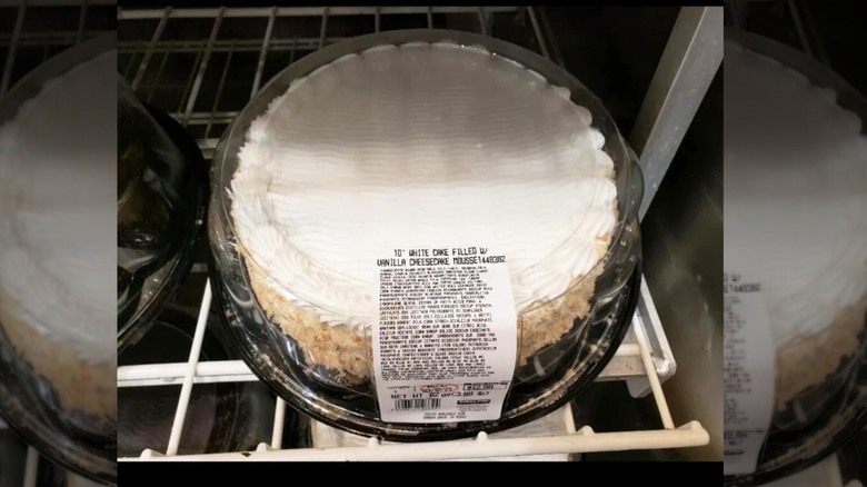 A white cake on a wire shelf at a Costco store