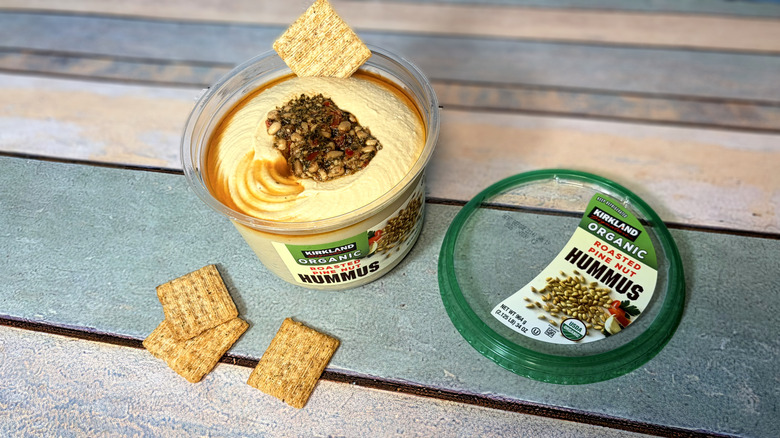 Open container of kirkland hummus with crackers