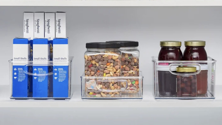 bins on pantry shelf filled with food items