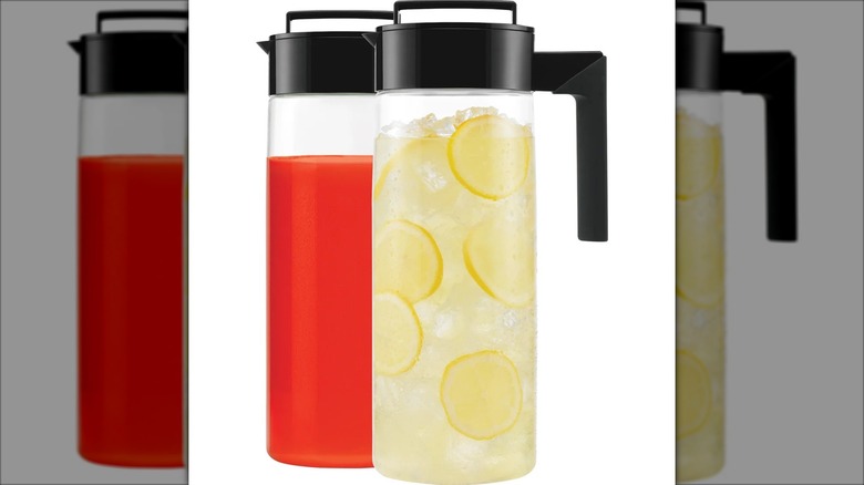 two slim pitchers filled with beverages