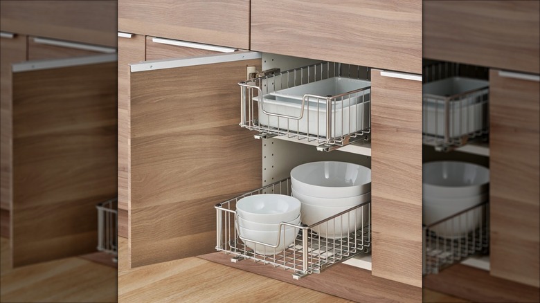two sliding metal drawers inside kitchen cabinet