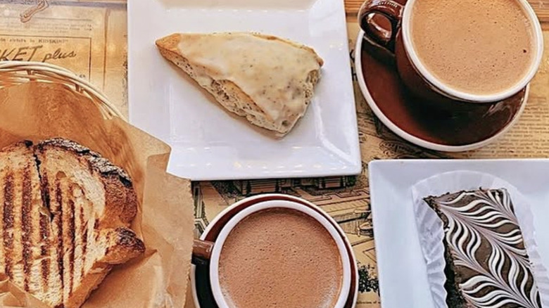 Coffee and pastries on a newspaper