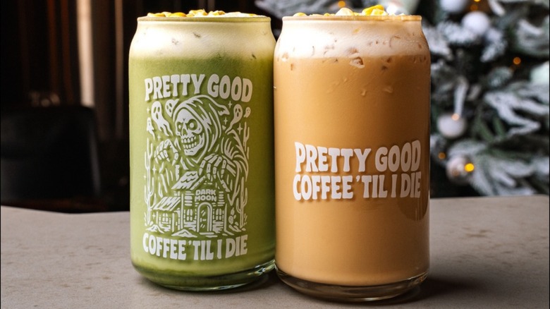 Glass of matcha next to glass cup of coffee