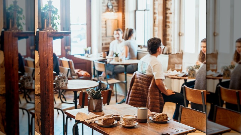 People sitting at tables in Harken Cafe with coffee and pastries