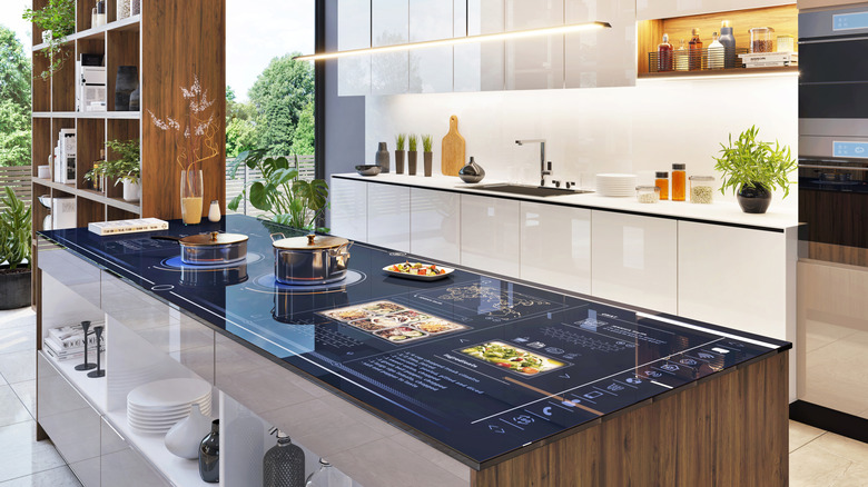 Modern kitchen with screens on counter and induction stove
