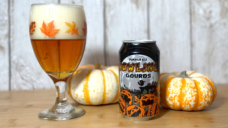 Glass and can of pumpkin ale with pumpkin decorations