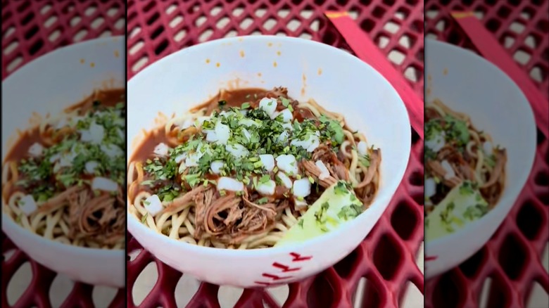 A bowl of ramen on an outdoor table