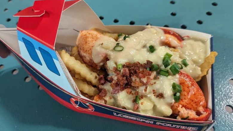 A cardboard boat container filled with lobster poutine