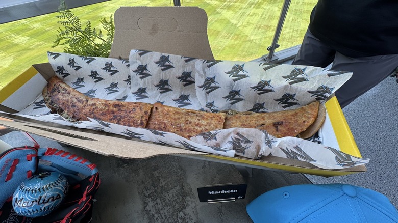 A machete quesadilla in its carrying case, sliced into quarters