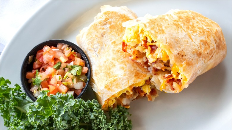 Open breakfast burrito with salsa