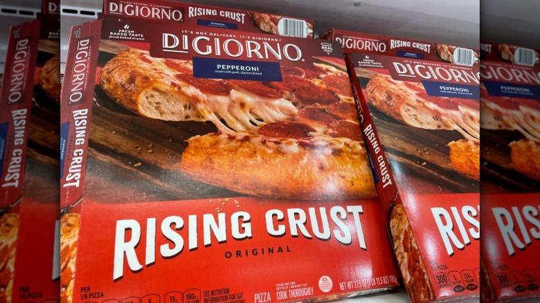 boxes of DiGiorno rising crust pepperoni pizza in a grocery store freezer
