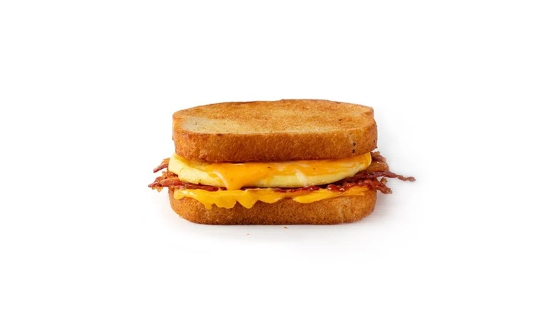 Breakfast grilled cheese sandwich with melted cheese, eggs, and bacon