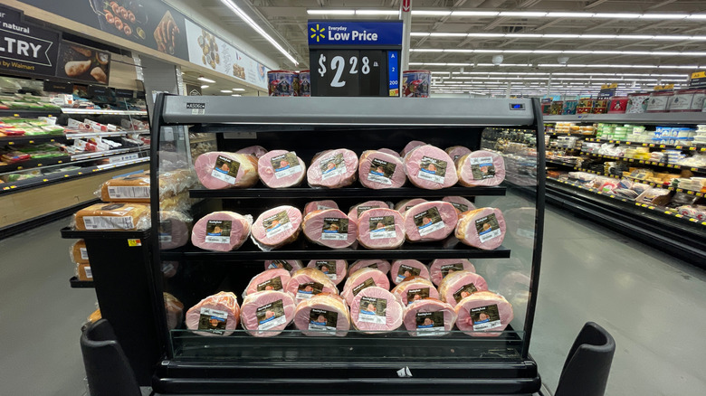 a view of a Walmart grocery aisle with hams shown marked for an everyday low price