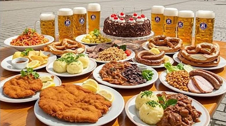 Many German foods and beers arranged on a wooden table