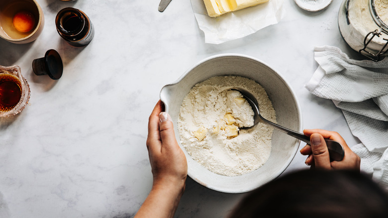 mixing bowl filled with flour and butter