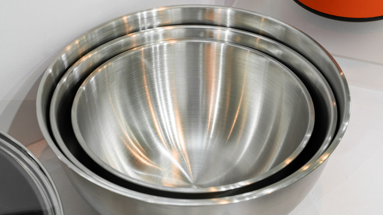 A stack of nested stainless steel mixing bowls