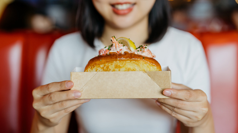 Woman holding a lobster roll