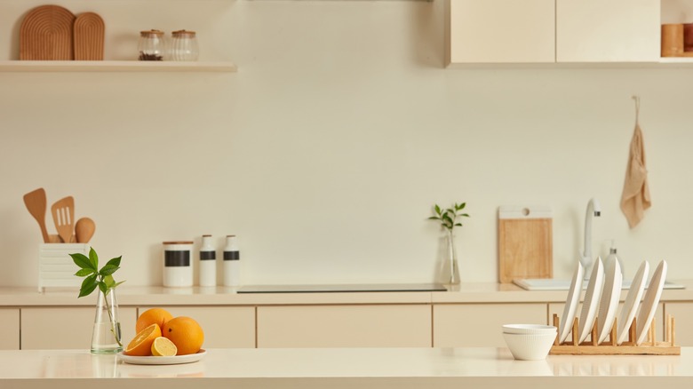 a kitchen counter space with organized plates and jars