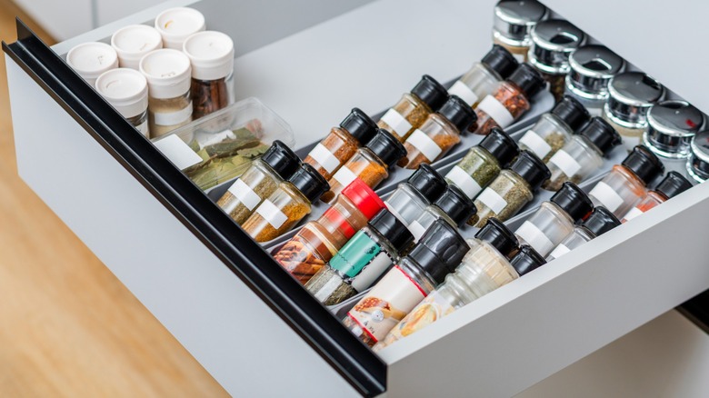 spices lined in a spice organizer in a drawer