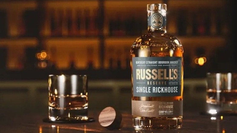 A bottle of Russell's Reserve Single Rickhouse – Camp Nelson F (2025) next to a glass on a bar top