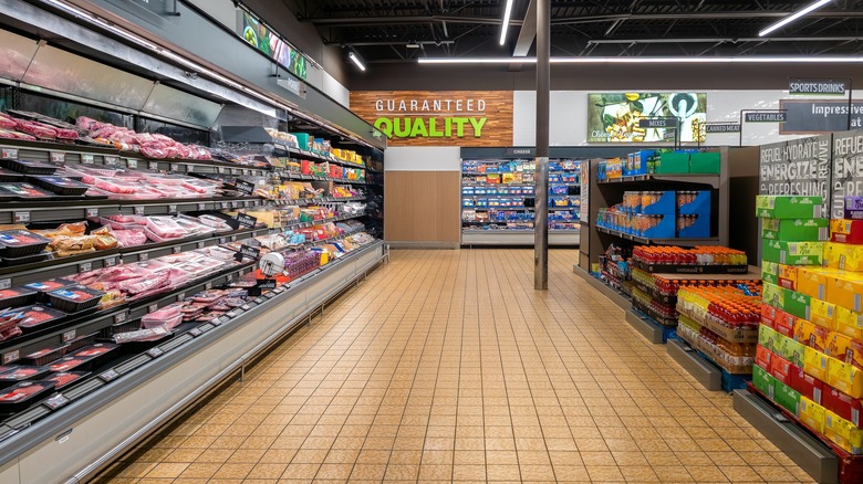 Aldi aisle with meats (left), drinks (right), and cheese (center background)