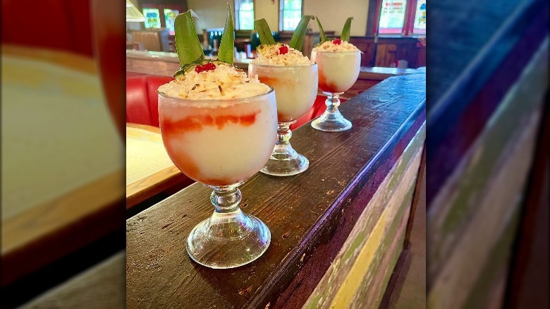 Three large Piña Coladas on bar
