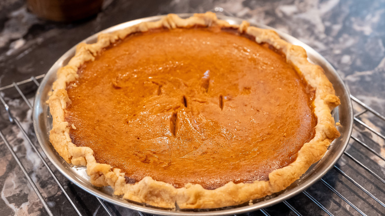 pumpkin pie in a metal pie tin