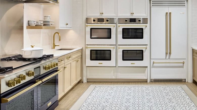 Kitchen in the Abt Electronics showroom displaying ranges, built-in ovens, and refrigerator