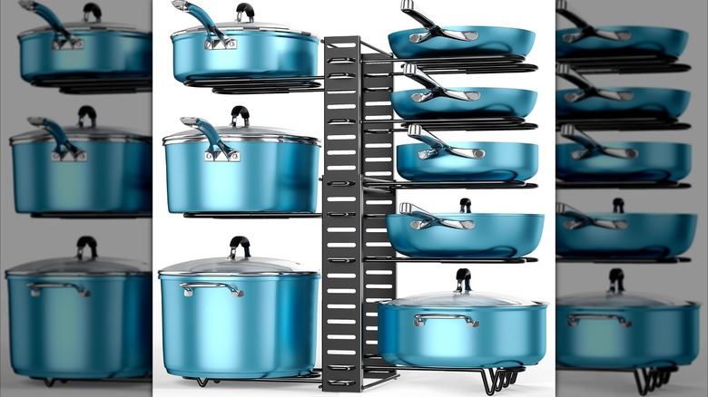 The 8-tier pot and pan organizer holding up 8 blue pots and pans of various sizes