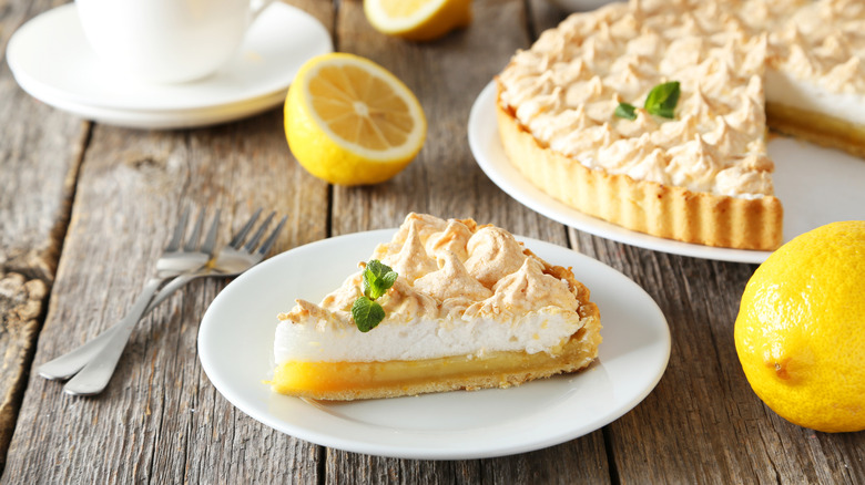 Slice of lemon meringue pie on white plate