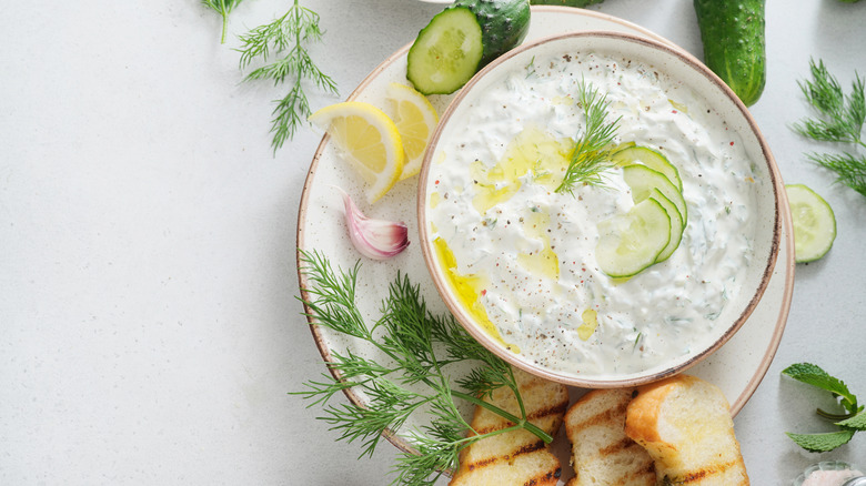 Bowl of tzatziki with cucumber, lemon, dill, and garlic.