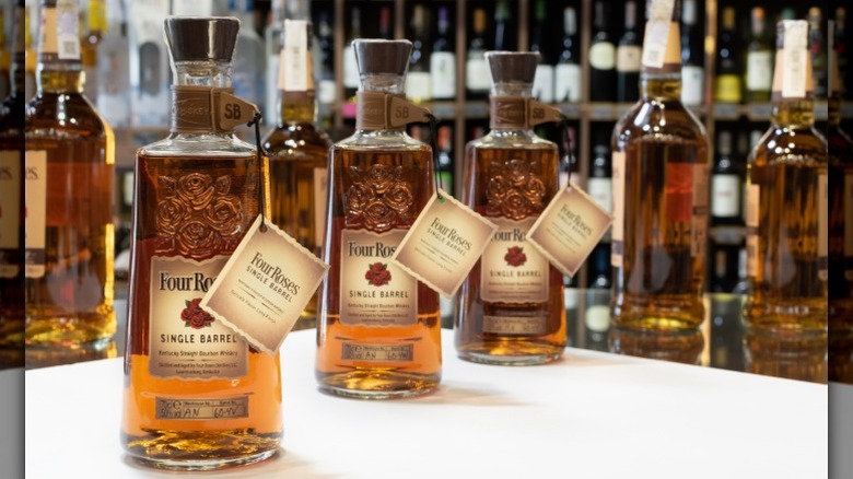 Three bottles Four Roses Single Barrel Bourbon on a table in a liquor store