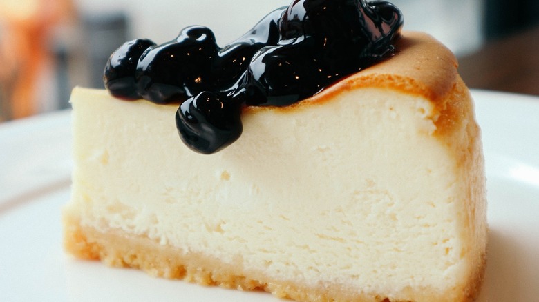 Fluffy cheesecake slice topped with berry compote