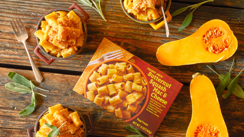 A package of Trader Joe's Butternut Squash Mac & Cheese next to bowls and herbs