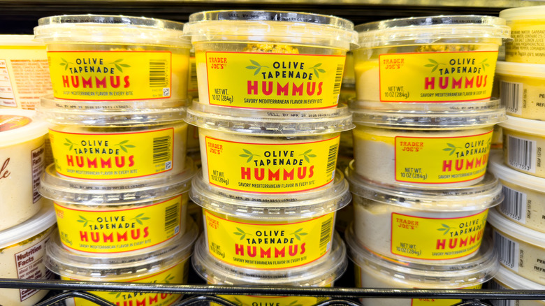 A shelf display of Trader Joe's Olive Tapenade Hummus