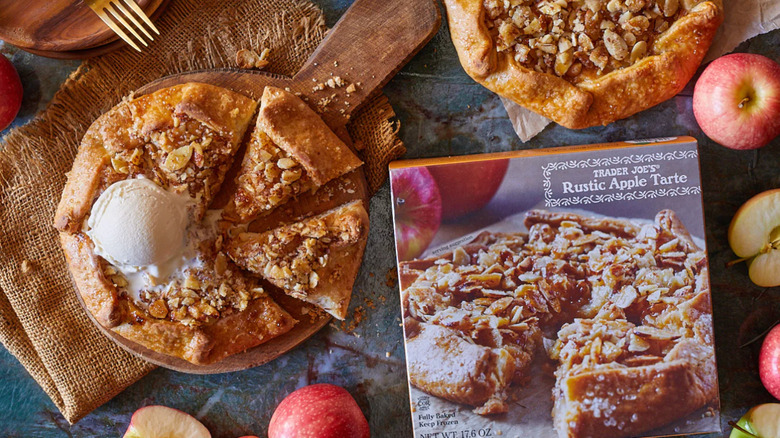 A plated rustic apple tarte next to a package and apples