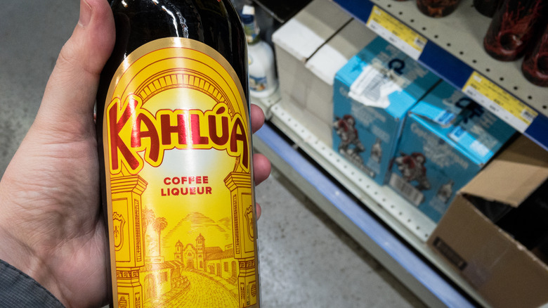 Hand holding bottle of Kahlua