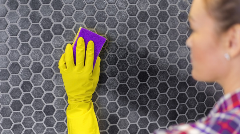 Woman cleaning kitchen tiles