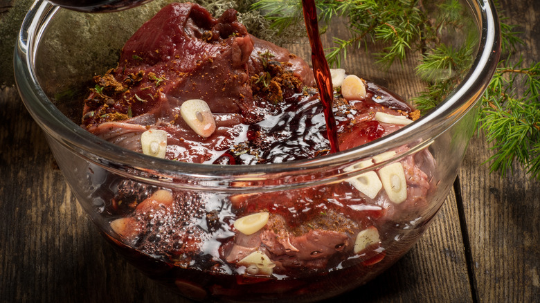 marinating beef in bowl with garlic
