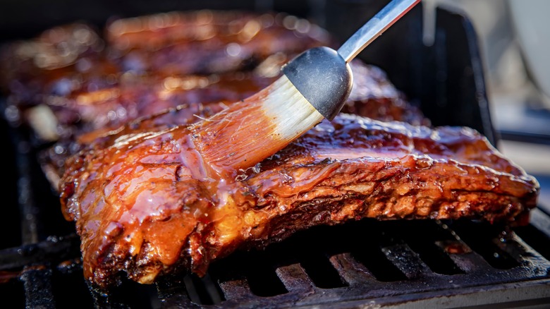 meat being basted and barbecued
