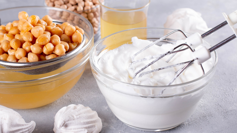 Chickpeas being drained of aquafaba next to whipped aquafaba meringue
