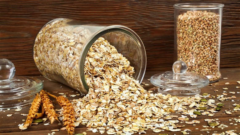 Oats spilling from glass container 