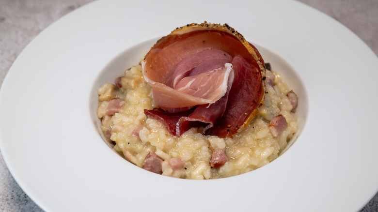 Bacon risotto, with a slice of cured ham on top