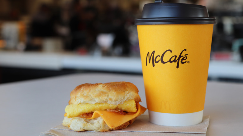 A McDonald's Bacon Egg Cheese Biscuit is pictured next to a McCafé drink